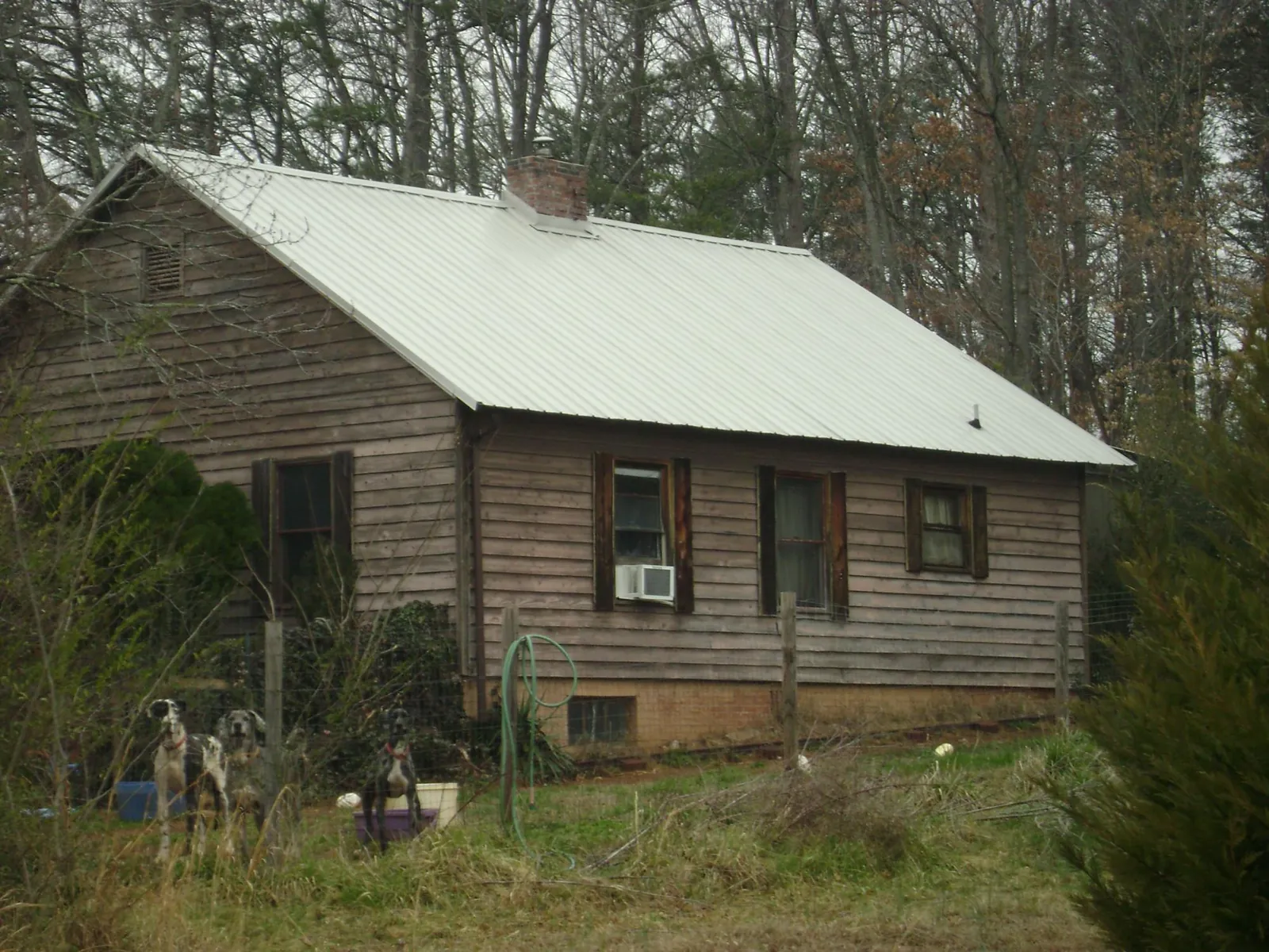 White metal roof on an old wood sided farmhouse, from a Metal Roof Installation job in Deep River